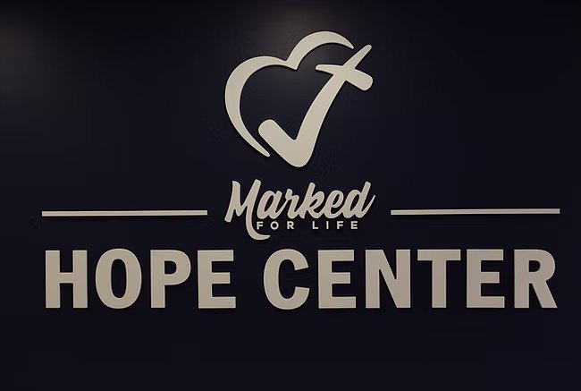Marked For Life Hope Center sign on a navy wall
