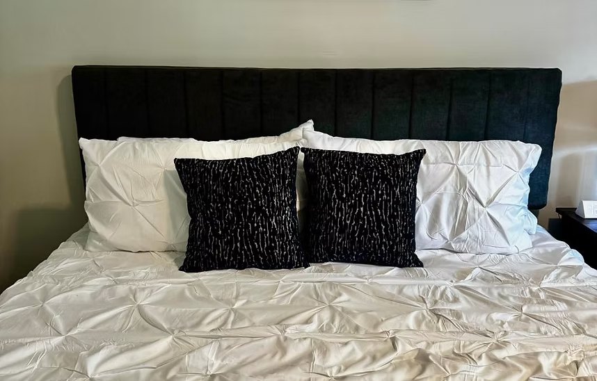 A freshly made bed in a renovated Hope House room