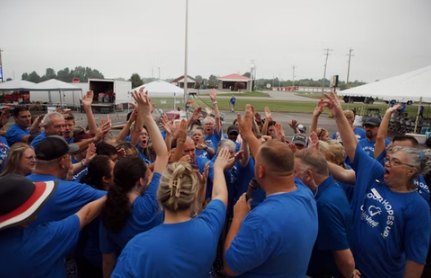 Volunteers gathered in a prayer huddle