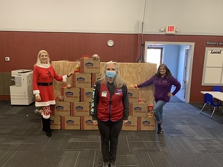 Volunteers with boxes of Christmas gifts for children