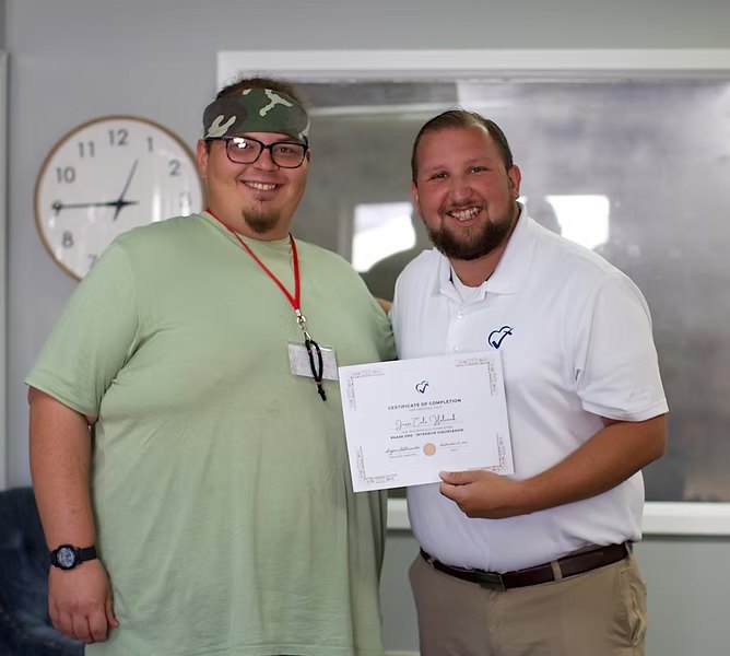 A Hope House participant receiving a certificate of completion