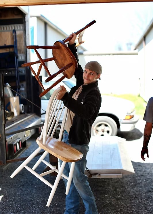 A Hope House resident unloading donated chairs from the ministry truck